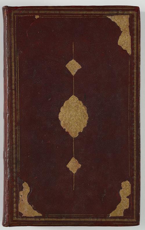 View of the back of a book bound in dark brown leather. There is a border of gold-embossed tooling, with large corner shapes and a central medallion with small pendants. The gold foil is falling off and not complete