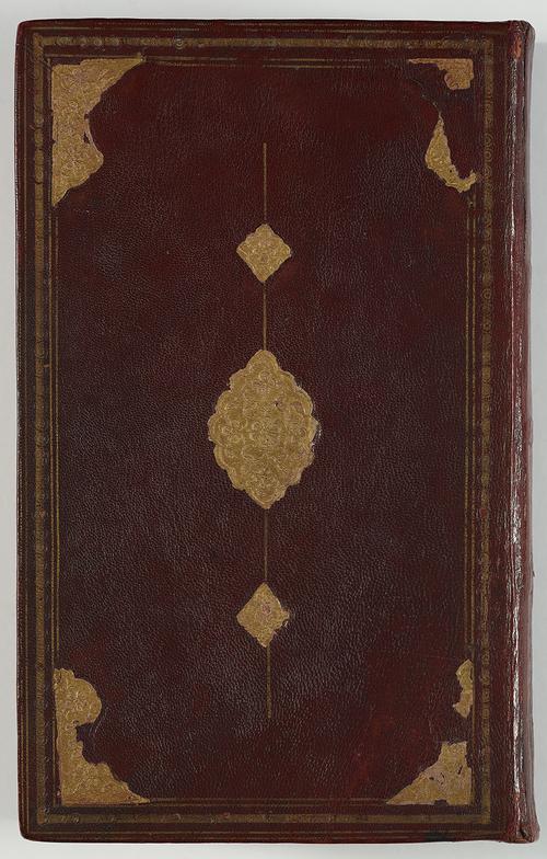 View of the front of a book bound in dark brown leather. There is a border of gold-embossed tooling, with large corner shapes and a central medallion with small pendants. The gold foil is falling off and not complete.