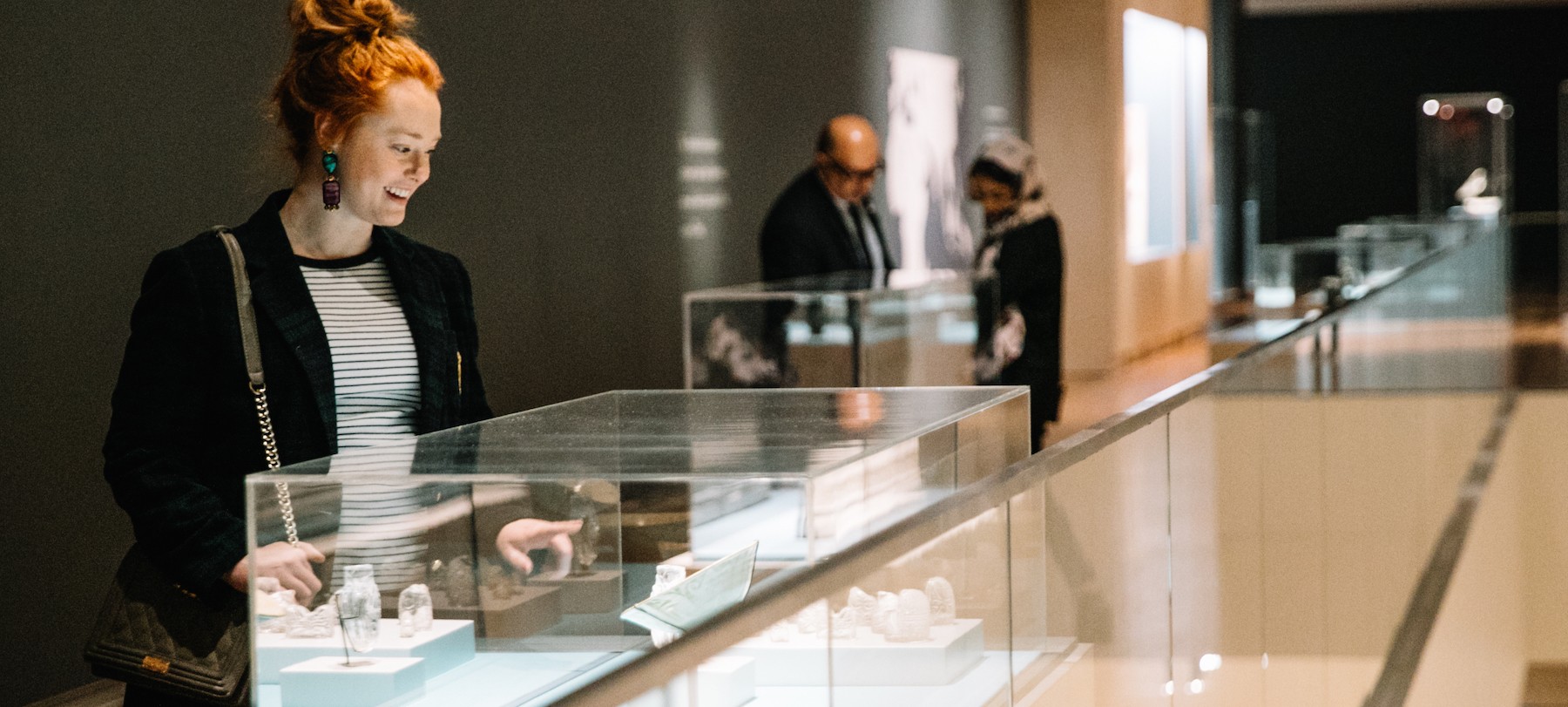 Lady looking at an object case in the AKM